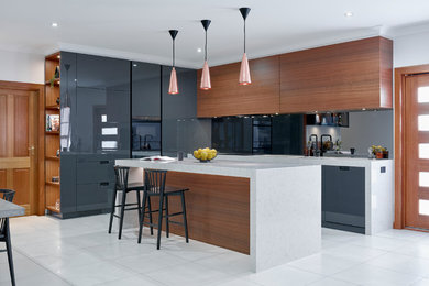 Inspiration for a medium sized contemporary grey and brown l-shaped kitchen/diner in Other with flat-panel cabinets, mirror splashback, white floors, grey cabinets, integrated appliances and an island.