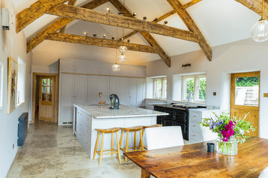 This is an example of a traditional kitchen in Gloucestershire with a built-in sink and black appliances.