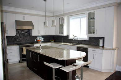 Large contemporary u-shaped kitchen/diner in Toronto with a built-in sink, shaker cabinets, white cabinets, granite worktops, black splashback, mosaic tiled splashback, stainless steel appliances, porcelain flooring and an island.