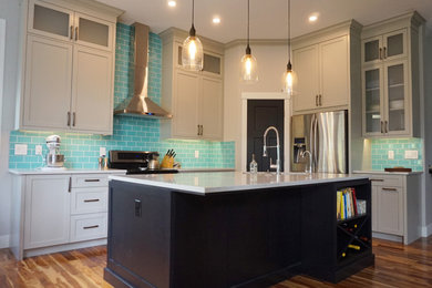 Kitchen - mid-sized transitional l-shaped medium tone wood floor and brown floor kitchen idea in Calgary with an undermount sink, quartz countertops, blue backsplash, ceramic backsplash, stainless steel appliances, shaker cabinets, gray cabinets and an island