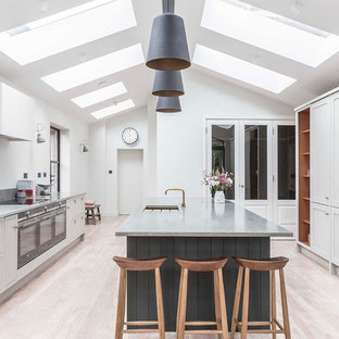 Classic kitchen in West Midlands with a submerged sink, shaker cabinets, grey cabinets, light hardwood flooring, an island, beige floors and grey worktops.