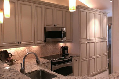Example of a small classic u-shaped ceramic tile kitchen pantry design in Miami with an undermount sink, raised-panel cabinets, medium tone wood cabinets, quartz countertops, multicolored backsplash, stone tile backsplash and stainless steel appliances