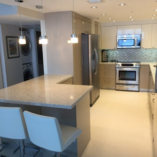 Mid-sized modern u-shaped kitchen pantry in Miami with an undermount sink, flat-panel cabinets, white cabinets, recycled glass benchtops, grey splashback, glass tile splashback, stainless steel appliances, porcelain floors and a peninsula.