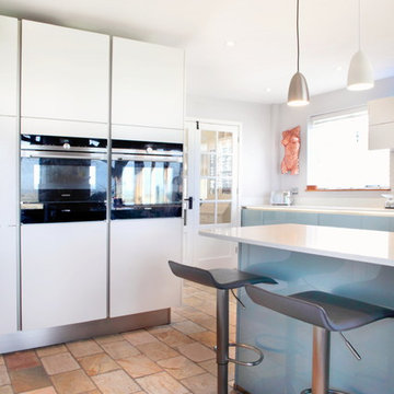 High gloss blue & matt white kitchen with breakfast bar