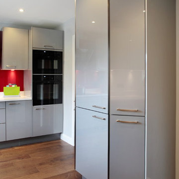 High gloss grey kitchen with tall storage units