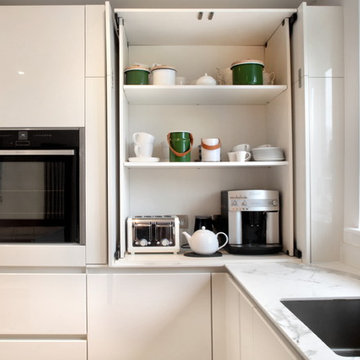 High gloss white & grey contemporary kitchen with hidden storage