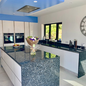 High Gloss White True Hanel-less kitchen with Blue Pearl Granite Worktops