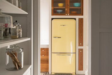 Inspiration for an eclectic kitchen remodel in Austin with colored appliances and medium tone wood cabinets