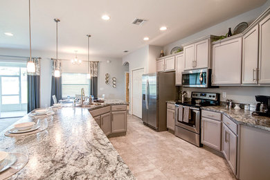 Eat-in kitchen - mid-sized contemporary single-wall ceramic tile and beige floor eat-in kitchen idea in Tampa with an undermount sink, recessed-panel cabinets, gray cabinets, granite countertops, stainless steel appliances and an island