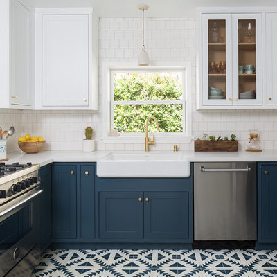 Inspiration for a mid-sized craftsman u-shaped cement tile floor and blue floor enclosed kitchen remodel in Los Angeles with a farmhouse sink, shaker cabinets, blue cabinets, quartz countertops, white backsplash, ceramic backsplash, stainless steel appliances and no island