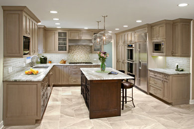 Mid-sized transitional u-shaped eat-in kitchen photo in Chicago with recessed-panel cabinets and an island