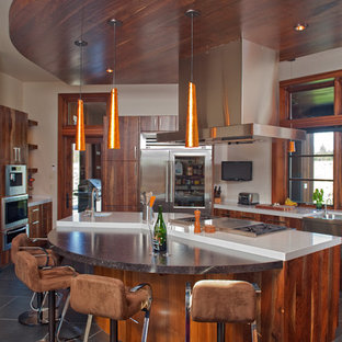 Large craftsman open concept kitchen photos - Example of a large arts and crafts u-shaped slate floor and gray floor open concept kitchen design in Other with an undermount sink, flat-panel cabinets, medium tone wood cabinets, quartzite countertops, white backsplash, stone slab backsplash, stainless steel appliances and an island