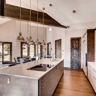 This is an example of a large modern single-wall open plan kitchen in Denver with an undermount sink, flat-panel cabinets, grey cabinets, marble benchtops, brown splashback, slate splashback, stainless steel appliances, dark hardwood floors, with island and brown floor.