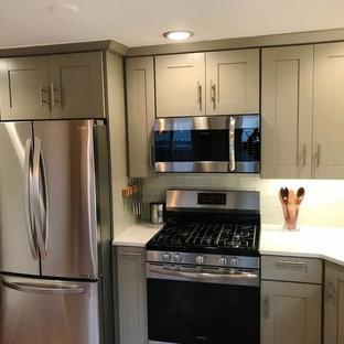Small transitional l-shaped eat-in kitchen in Denver with an undermount sink, shaker cabinets, green cabinets, granite benchtops, white splashback, glass tile splashback, stainless steel appliances, no island, porcelain floors and red floor.