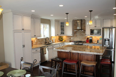 Huge elegant l-shaped dark wood floor kitchen photo in Denver with an undermount sink, beaded inset cabinets, white cabinets, granite countertops, beige backsplash, stone tile backsplash, stainless steel appliances and an island