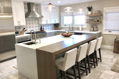 Large transitional porcelain tile and gray floor eat-in kitchen photo in Denver with an undermount sink, shaker cabinets, gray cabinets, quartz countertops, gray backsplash, porcelain backsplash, stainless steel appliances, an island and white countertops