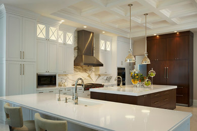 Example of a large classic single-wall eat-in kitchen design in Miami with an undermount sink, recessed-panel cabinets, white cabinets, quartz countertops, multicolored backsplash, marble backsplash, paneled appliances, two islands and white countertops