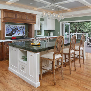 Design ideas for a large traditional single-wall eat-in kitchen in San Francisco with beaded inset cabinets, green splashback, subway tile splashback, stainless steel appliances, with island, light hardwood floors, medium wood cabinets and green benchtop.