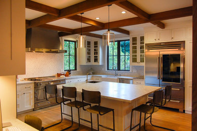 Large transitional u-shaped medium tone wood floor eat-in kitchen photo in San Francisco with a farmhouse sink, white cabinets, stainless steel appliances, an island, shaker cabinets, marble countertops, multicolored backsplash and stone tile backsplash