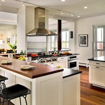Trendy open concept kitchen photo in Burlington with stainless steel appliances, soapstone countertops, shaker cabinets and white cabinets