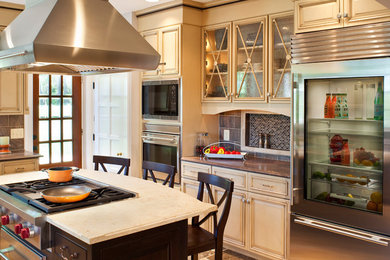 Example of a large transitional l-shaped ceramic tile eat-in kitchen design in Baltimore with an undermount sink, raised-panel cabinets, beige cabinets, granite countertops, brown backsplash, ceramic backsplash, stainless steel appliances and an island