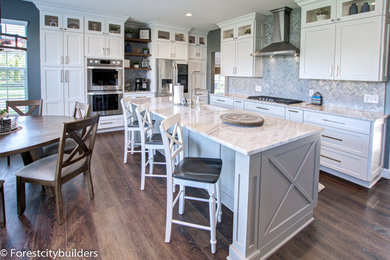 Large minimalist kitchen photo in Cleveland with shaker cabinets, white cabinets, quartzite countertops, an island and white countertops