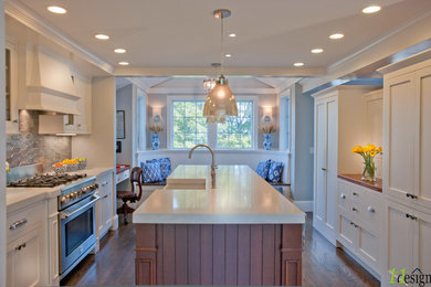 Inspiration for a large transitional galley dark wood floor eat-in kitchen remodel in Boston with a farmhouse sink, recessed-panel cabinets, medium tone wood cabinets, solid surface countertops, gray backsplash, ceramic backsplash, paneled appliances and an island