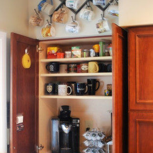 Design ideas for a mid-sized country u-shaped kitchen in Cleveland with an undermount sink, flat-panel cabinets, medium wood cabinets, quartz benchtops, multi-coloured splashback, slate splashback, stainless steel appliances, vinyl floors, a peninsula and brown floor.