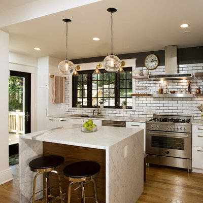 Inspiration for a mid-sized transitional medium tone wood floor kitchen remodel in DC Metro with an undermount sink, flat-panel cabinets, white cabinets, granite countertops, white backsplash, stainless steel appliances, an island and subway tile backsplash