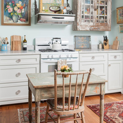Inspiration for a shabby-chic style eat-in kitchen remodel in Wilmington with recessed-panel cabinets, distressed cabinets, white appliances and marble countertops