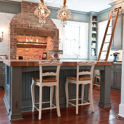 Inspiration for a large timeless u-shaped kitchen remodel in Philadelphia with blue cabinets and wood countertops