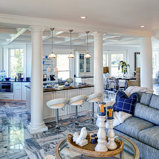 This is an example of a mid-sized traditional u-shaped open plan kitchen in Other with an undermount sink, beaded inset cabinets, white cabinets, granite benchtops, stainless steel appliances, marble floors, with island and multi-coloured floor.