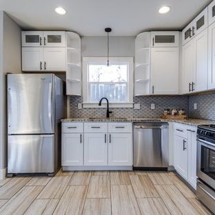 Photo of a small transitional u-shaped eat-in kitchen in Austin with an undermount sink, shaker cabinets, white cabinets, granite benchtops, white splashback, mosaic tile splashback, stainless steel appliances, porcelain floors and no island.