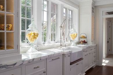 Example of a large cottage u-shaped dark wood floor open concept kitchen design in DC Metro with a farmhouse sink, beaded inset cabinets, white cabinets, marble countertops, multicolored backsplash, stone slab backsplash, paneled appliances and two islands