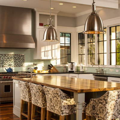 Arts and crafts u-shaped kitchen photo in Atlanta with stainless steel appliances, white cabinets, wood countertops, green backsplash, subway tile backsplash, a farmhouse sink and shaker cabinets