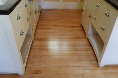 Inspiration for a mid-sized craftsman u-shaped light wood floor eat-in kitchen remodel in Los Angeles with recessed-panel cabinets, white cabinets, granite countertops and an island
