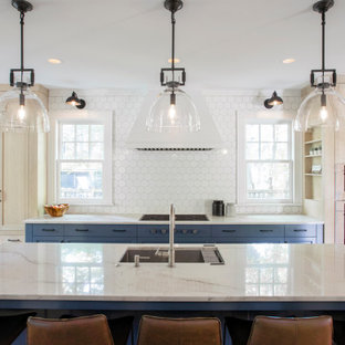 This is an example of an expansive transitional single-wall eat-in kitchen in Minneapolis with an undermount sink, blue cabinets, granite benchtops, white splashback, ceramic splashback, panelled appliances, medium hardwood floors, with island, blue benchtop and shaker cabinets.
