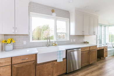 Inspiration for a small farmhouse galley vinyl floor enclosed kitchen remodel in Seattle with a farmhouse sink, shaker cabinets, quartz countertops, gray backsplash, porcelain backsplash, stainless steel appliances and white countertops