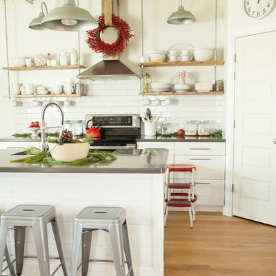 Kitchen - contemporary kitchen idea in Columbus with stainless steel appliances, open cabinets and solid surface countertops