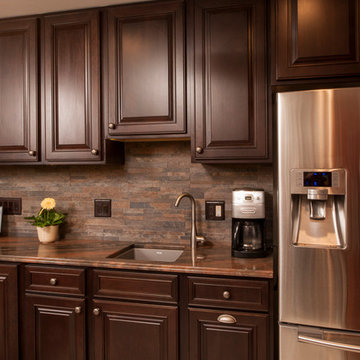 Holiday Kitchens Cherry Cabinets, Copper Dune Quartzite counters, stacked stone