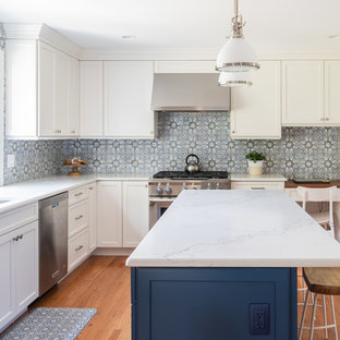 Mid-sized transitional eat-in kitchen designs - Mid-sized transitional l-shaped medium tone wood floor and brown floor eat-in kitchen photo in Philadelphia with an undermount sink, recessed-panel cabinets, white cabinets, quartzite countertops, multicolored backsplash, ceramic backsplash, stainless steel appliances, an island and white countertops