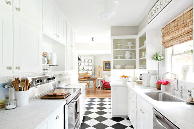 Enclosed kitchen - small traditional galley multicolored floor enclosed kitchen idea in Houston with a single-bowl sink, recessed-panel cabinets, white cabinets, white backsplash, subway tile backsplash and stainless steel appliances