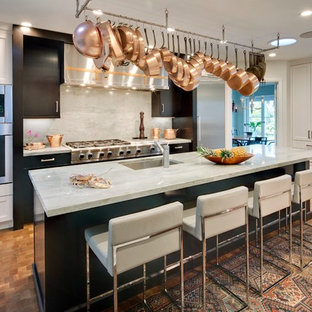 Large transitional enclosed kitchen remodeling - Example of a large transitional l-shaped medium tone wood floor enclosed kitchen design in Los Angeles with an undermount sink, white cabinets, quartzite countertops, gray backsplash, stone slab backsplash, stainless steel appliances, an island and shaker cabinets