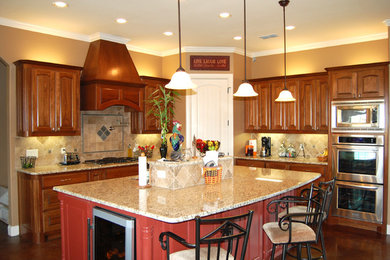 Example of a mid-sized classic l-shaped concrete floor eat-in kitchen design in Dallas with a double-bowl sink, raised-panel cabinets, medium tone wood cabinets, granite countertops, beige backsplash, porcelain backsplash, stainless steel appliances and an island