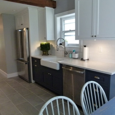 Inspiration for a mid-sized country galley concrete floor and gray floor eat-in kitchen remodel in New York with a farmhouse sink, shaker cabinets, white cabinets, solid surface countertops, white backsplash, terra-cotta backsplash, stainless steel appliances, no island and white countertops