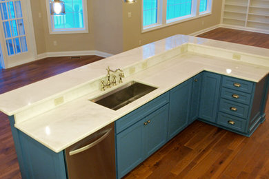 Example of a large classic galley medium tone wood floor open concept kitchen design in Grand Rapids with shaker cabinets, blue cabinets, white backsplash, subway tile backsplash, stainless steel appliances and an island