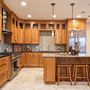 Inspiration for a mid-sized arts and crafts u-shaped eat-in kitchen in New York with a drop-in sink, glass-front cabinets, light wood cabinets, granite benchtops, grey splashback, subway tile splashback, stainless steel appliances, ceramic floors, with island and beige floor.