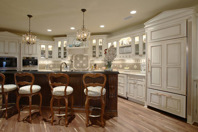 Inspiration for a large timeless medium tone wood floor open concept kitchen remodel in Cincinnati with an undermount sink, beaded inset cabinets, medium tone wood cabinets, granite countertops, multicolored backsplash, paneled appliances and an island