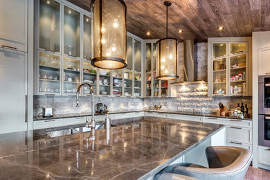 Example of a large trendy l-shaped medium tone wood floor open concept kitchen design in Calgary with a double-bowl sink, recessed-panel cabinets, gray cabinets, marble countertops, gray backsplash, stone tile backsplash, stainless steel appliances and an island