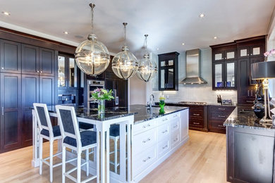 Example of a large transitional u-shaped light wood floor open concept kitchen design in Calgary with a double-bowl sink, recessed-panel cabinets, white cabinets, gray backsplash, ceramic backsplash, stainless steel appliances and an island